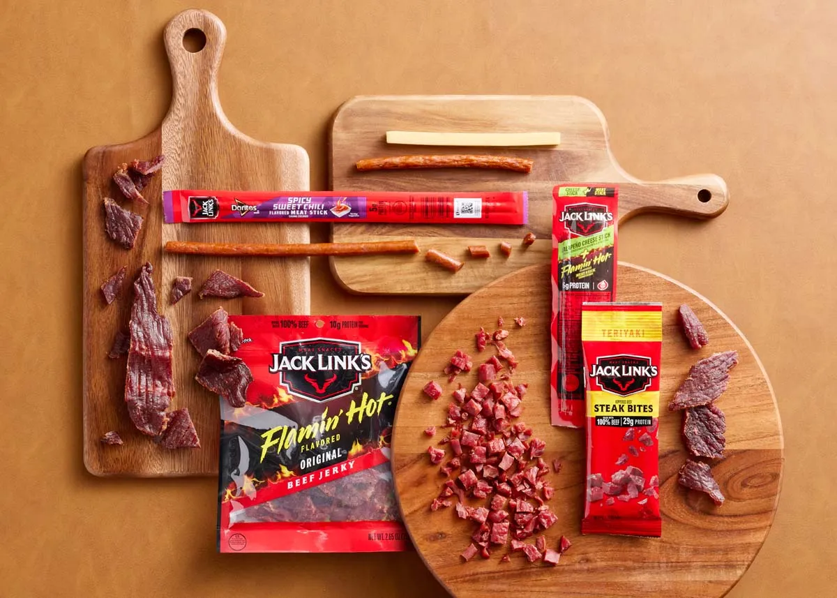 Jack Link's jerky and meat sticks on wooden cutting boards