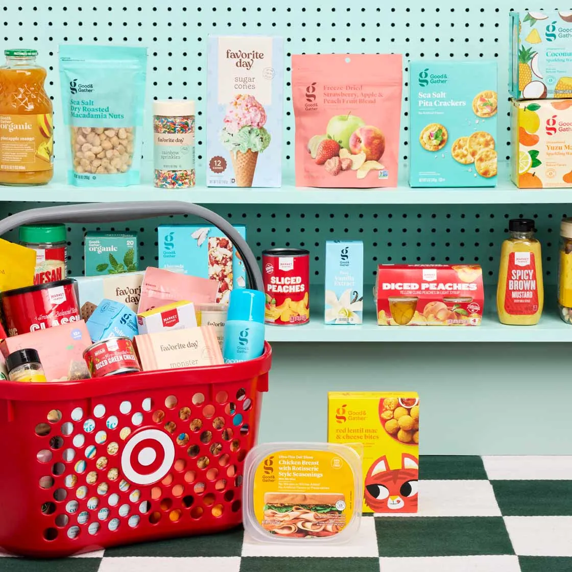 Target Good & Gather groceries on pegboard shelves above a red shopping basket