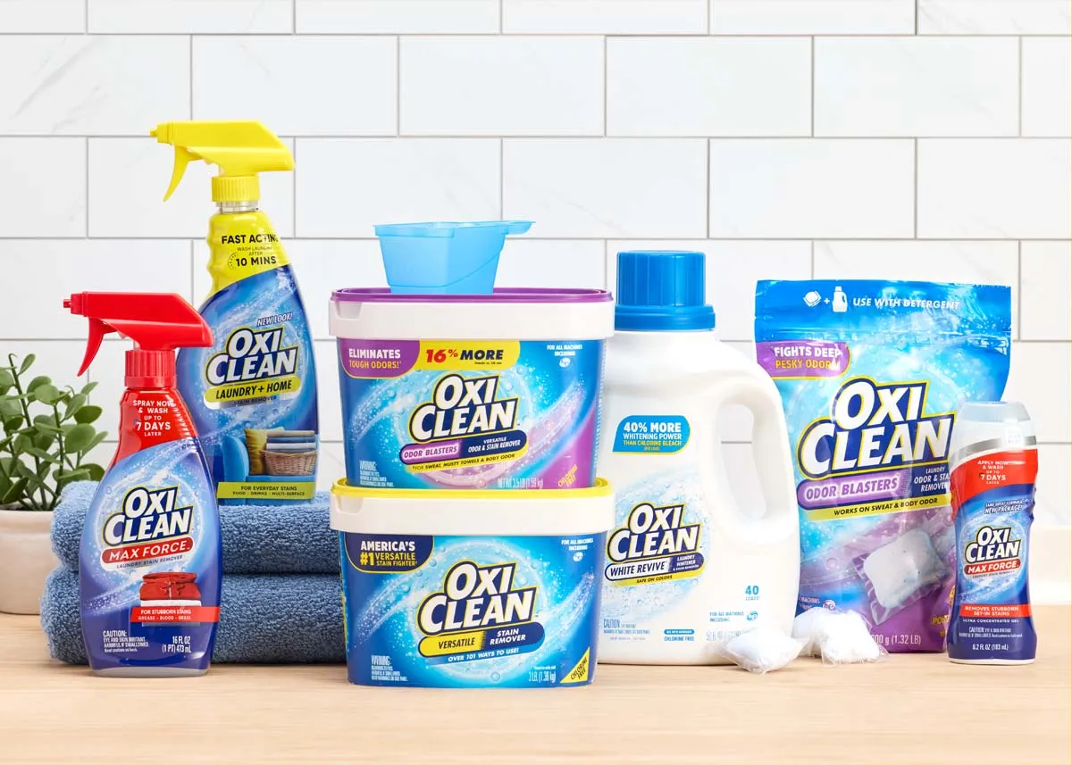 OxiClean laundry products lined up on a white tiled counter