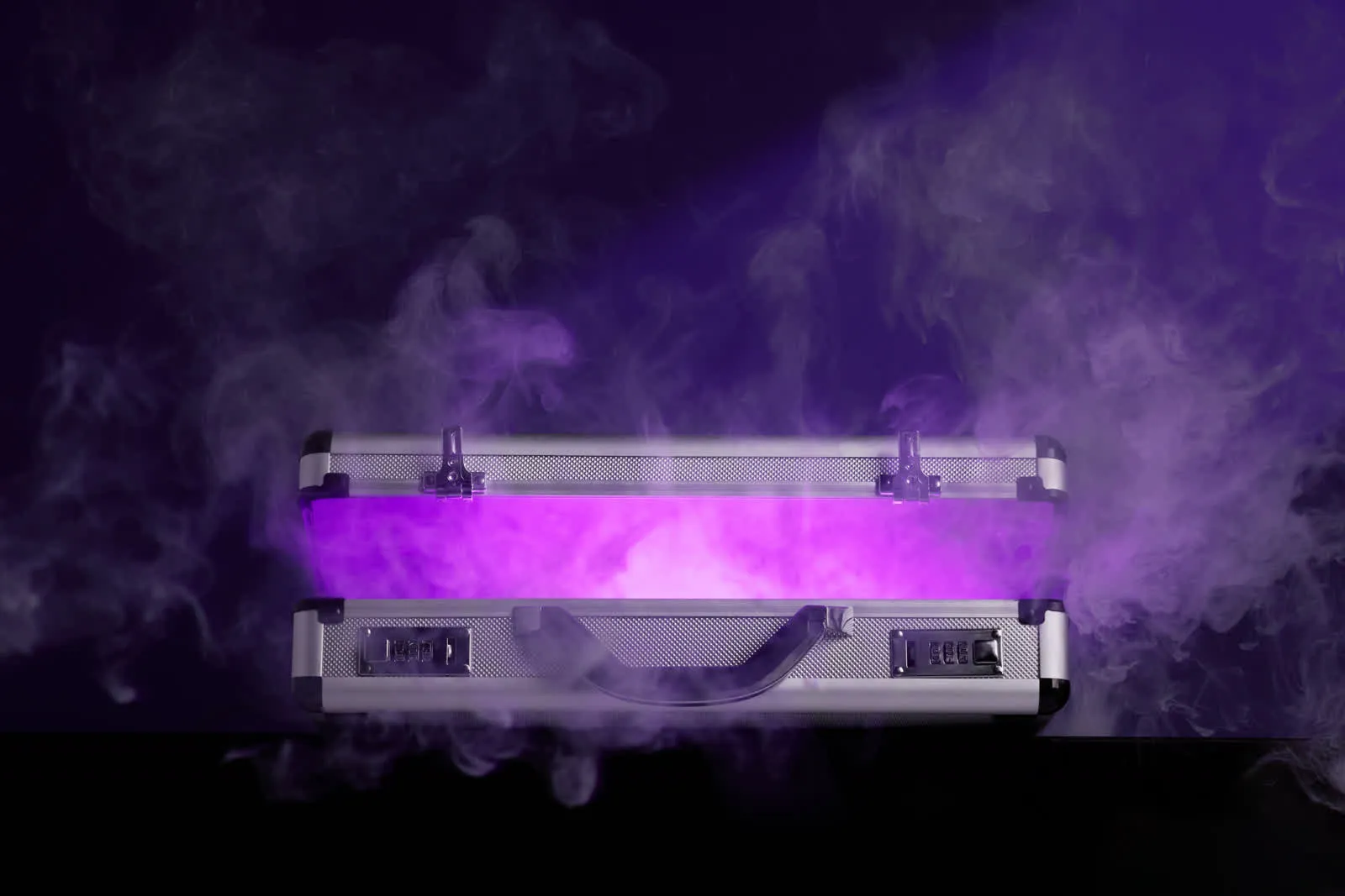 Silver case glowing purple in a cloud of smoke
